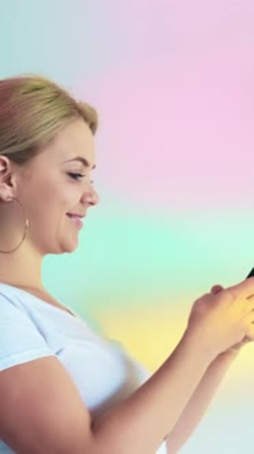 Woman Looking at Smartphone Device