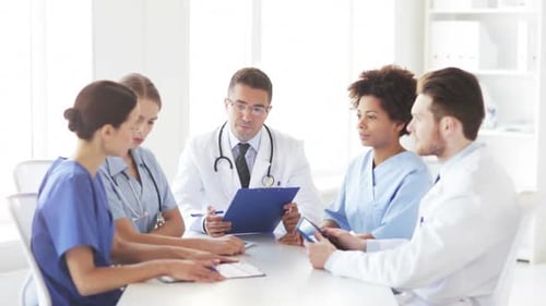 Diverse team of doctors discussing patient care at a hospital meeting