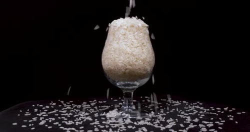 Rice Filling Stemmed Glass on Black Background