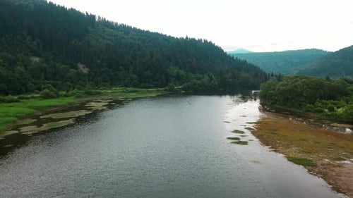 Aerial Drone Flight Over Beautiful Calm River Pond Lake Landscape Water Waves During Cloudy Day