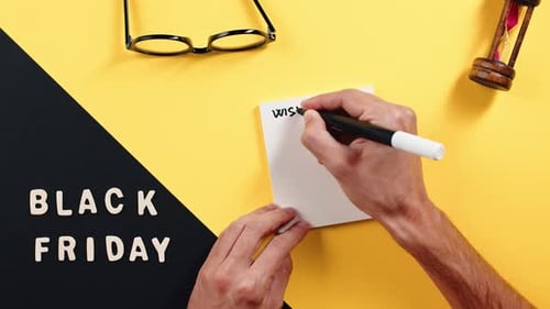 Writing Black Friday Wishlist on Paper