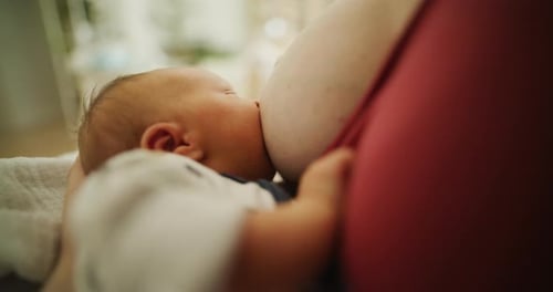 Infant nursing, close-up on baby's face