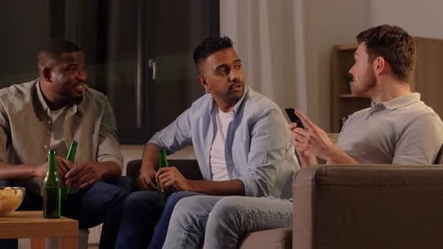 Friends Talking and Drinking Beer on a Couch