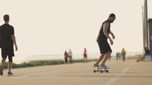 Adult Attractive Man Skating on Skateboard on the Street