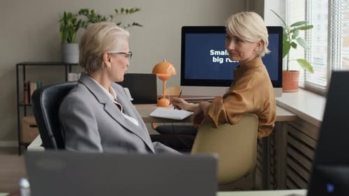Two Women Talking in an Office