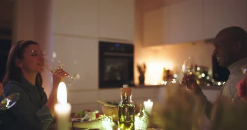 Friends Toasting Wine at Elegant Dinner Gathering