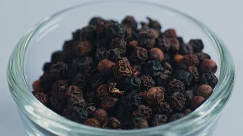 Bowl of Dried Black Peppercorns Close Up