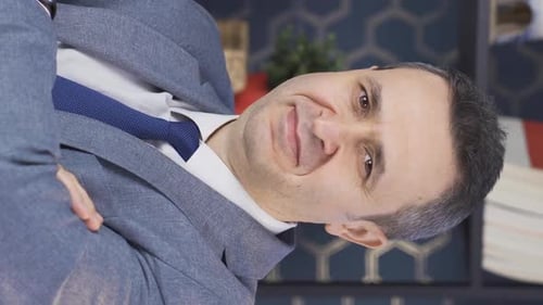 Vertical Video of Portrait of successful young businessman. Cute and smiling office worker.