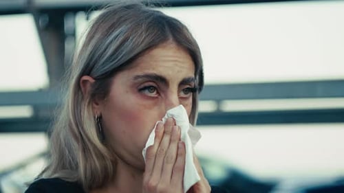 Woman Blowing Nose With Tissue