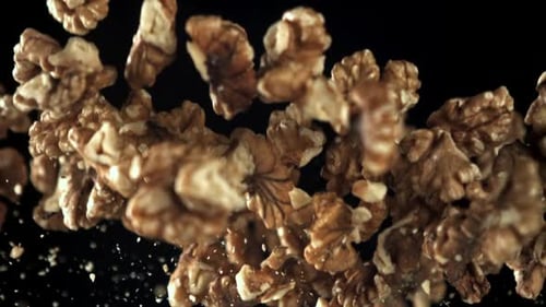 Halved Walnuts Floating on Black