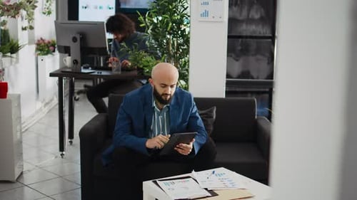 Man Using Tablet in Modern Office Workplace