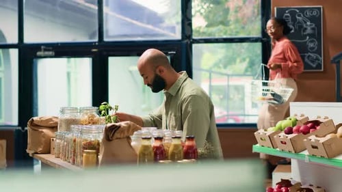 Man Arranging Goods in an Ecological Shop