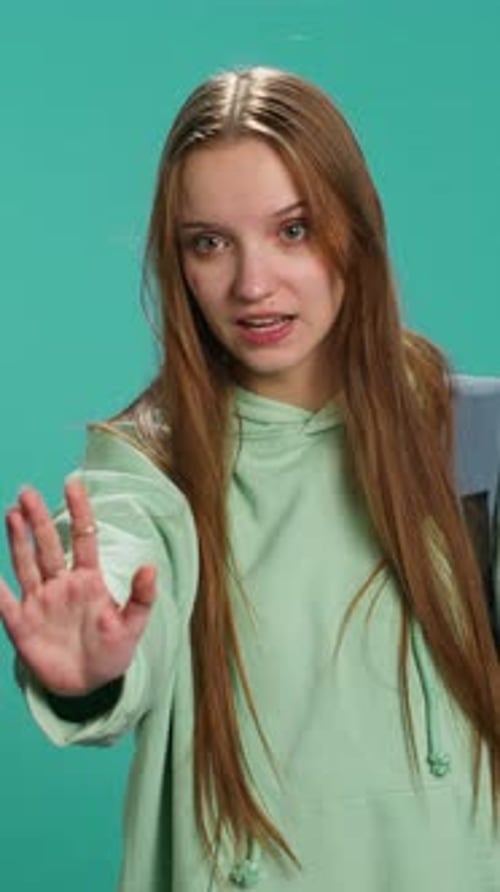 Vertical Video Assertive Young Woman Doing Stop Hand Gesture