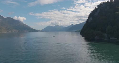4K Aerial - Medium shot push past cliffs on the right hand side Lake Como, Italy