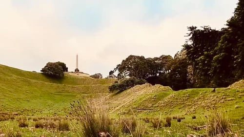 Time lapse looking upwards over a grassy hillside at One Tree Hill in Auckland New Zealand during a
