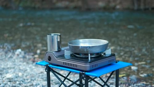 Portable Camping Stove and Pan Near River