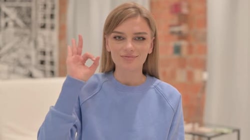 Young Adult Woman Gives OK Sign