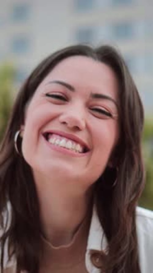 Vertical Individual Close Up Portrait of Young Woman Smiling and Looking at Camera with White Tooth