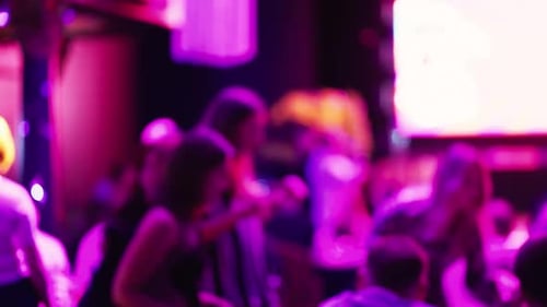 Blurred Crowd Enjoying Event with Colorful Lighting