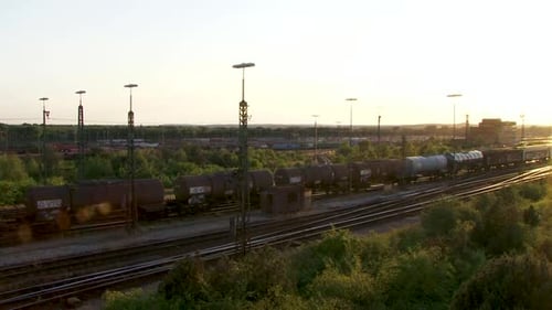 Anmutiger Güterzug, der durch eine ruhige Sonnenuntergangslandschaft gleitet