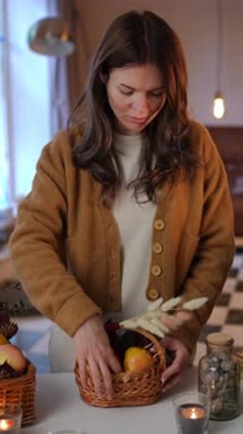 Woman Arranging Decorative Apples in Home Setting