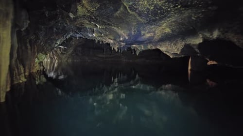 Boating on Underground River in Dark Cave