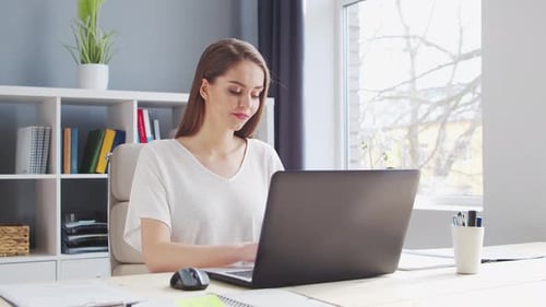 Young Woman Works at Home Office Using Computer Workplace of Female Entrepreneur Freelancer or