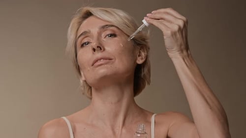 Woman Applying Facial Serum with a Pipette