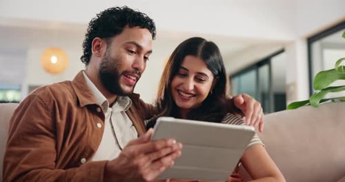 Couple, tablet and happy on sofa, talk and scroll on web with search for holiday resort