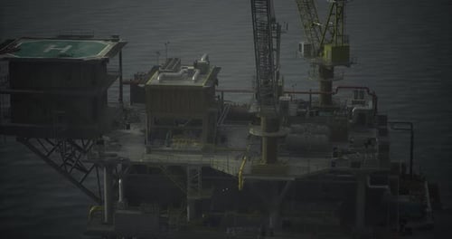 Oil Rig Structure Stands Tall in Open Waters During Overcast Weather