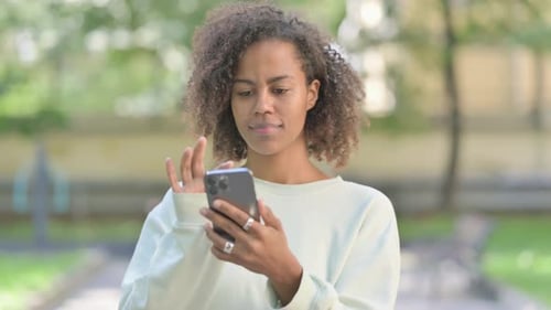 Woman Using Smartphone Outside in an Urban Park