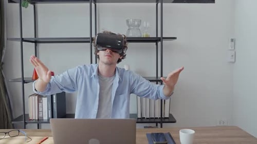 Man Using VR Headset at Desk in Modern Room