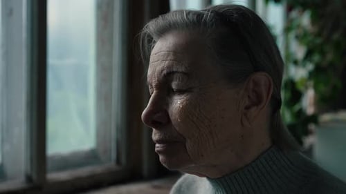 Elderly Woman Sitting by Window