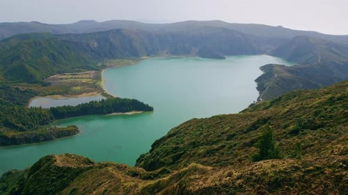 Untouched Lagoon Drone View in Morning Rough Volcanic Hills Covered By Greenery