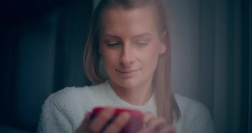 Woman Smiling Using Phone Indoors Close Up