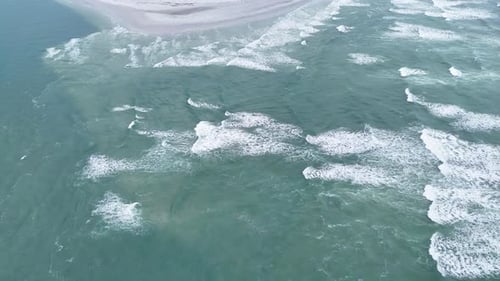 Ocean Waves Creating White Foam Patterns on Turquoise Water Drone Video