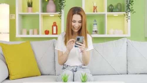 Young Woman Using Smartphone on Couch