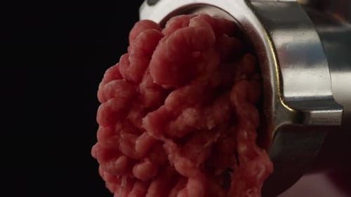 Twist a Meat or Pork Fart in a Meat Grinder Closeup Macro Mince Chicken Comes Out of the Meat