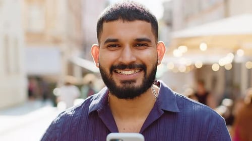 Man Using Phone Smiling in the City