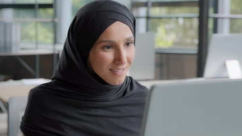 Woman With Headscarf Working At Computer, Celebrates Success