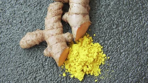 Fresh turmeric rhizome and powder. Yellow curcumin. Curcuma