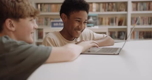 School Children Studying in Education Library using Laptop Technology