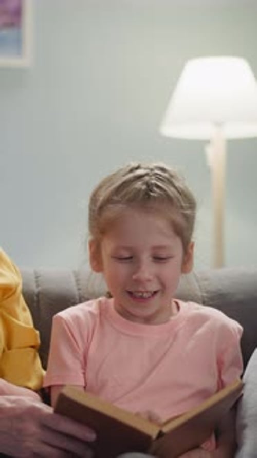 Grandmother Reading Book with Granddaughter