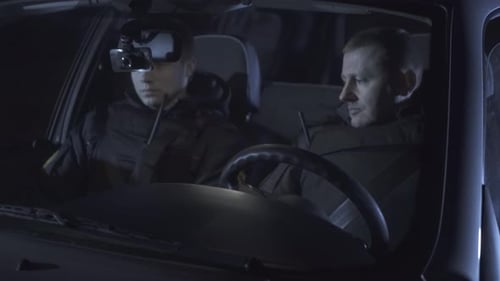 Men in Car Communicate Via Radio at Night