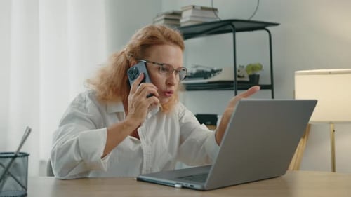 Woman Works at Desk, Talking on Phone