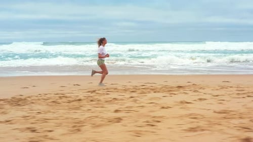 Drone Aerial Footage Blonde Woman Running By Sea in Morning