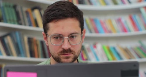 Close Up Portrait Man Student Preparing Exam and Learning Lessons in Library Making Research on
