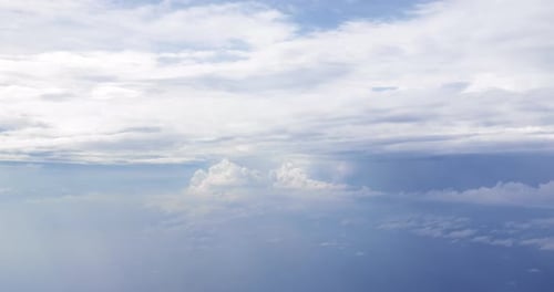 Flight over clouds, a view from a plane window - beautiful blue sky