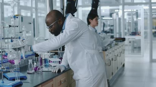 Man Working with Lab Equipment in a Bright Lab