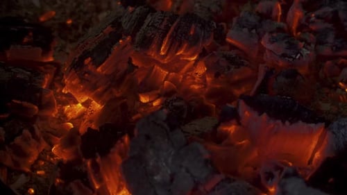 A warm and moody feel. The light seems to dance in the hot coal that glows from a previous fire.